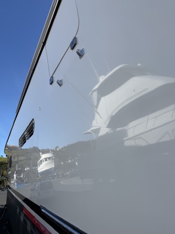 Close-up of a glossy, freshly polished and protected boat hull