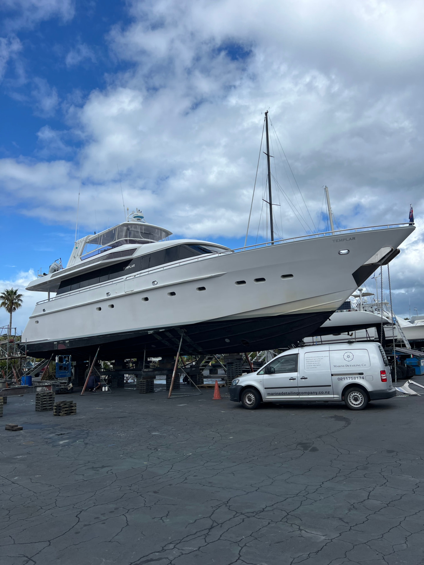 Marine Detailing Co. van parked beside a large motor yacht on the hardstand